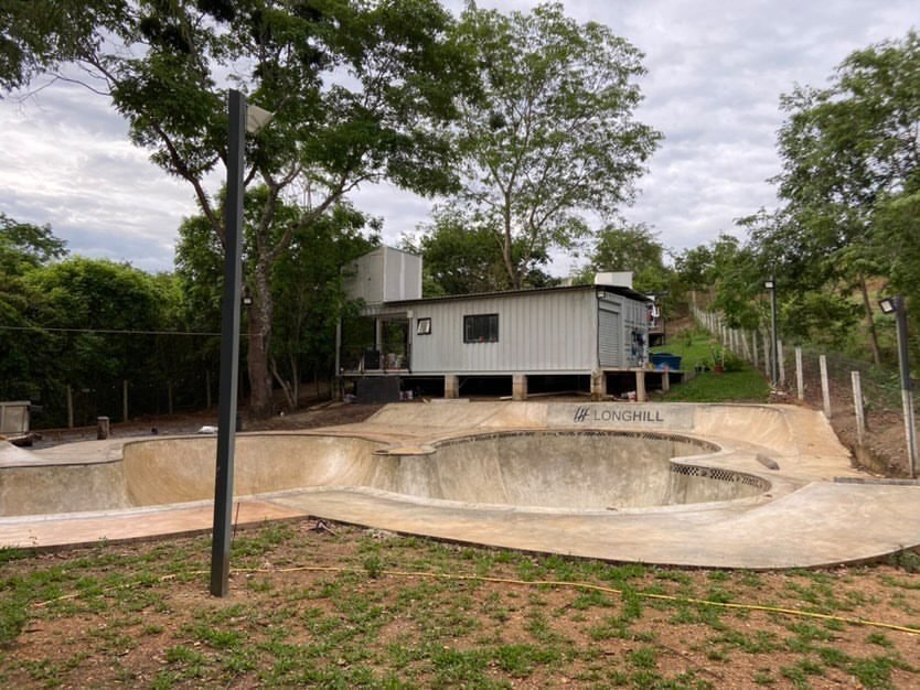 O bowl e a casa de contêineres vistos do nível do solo, de dia