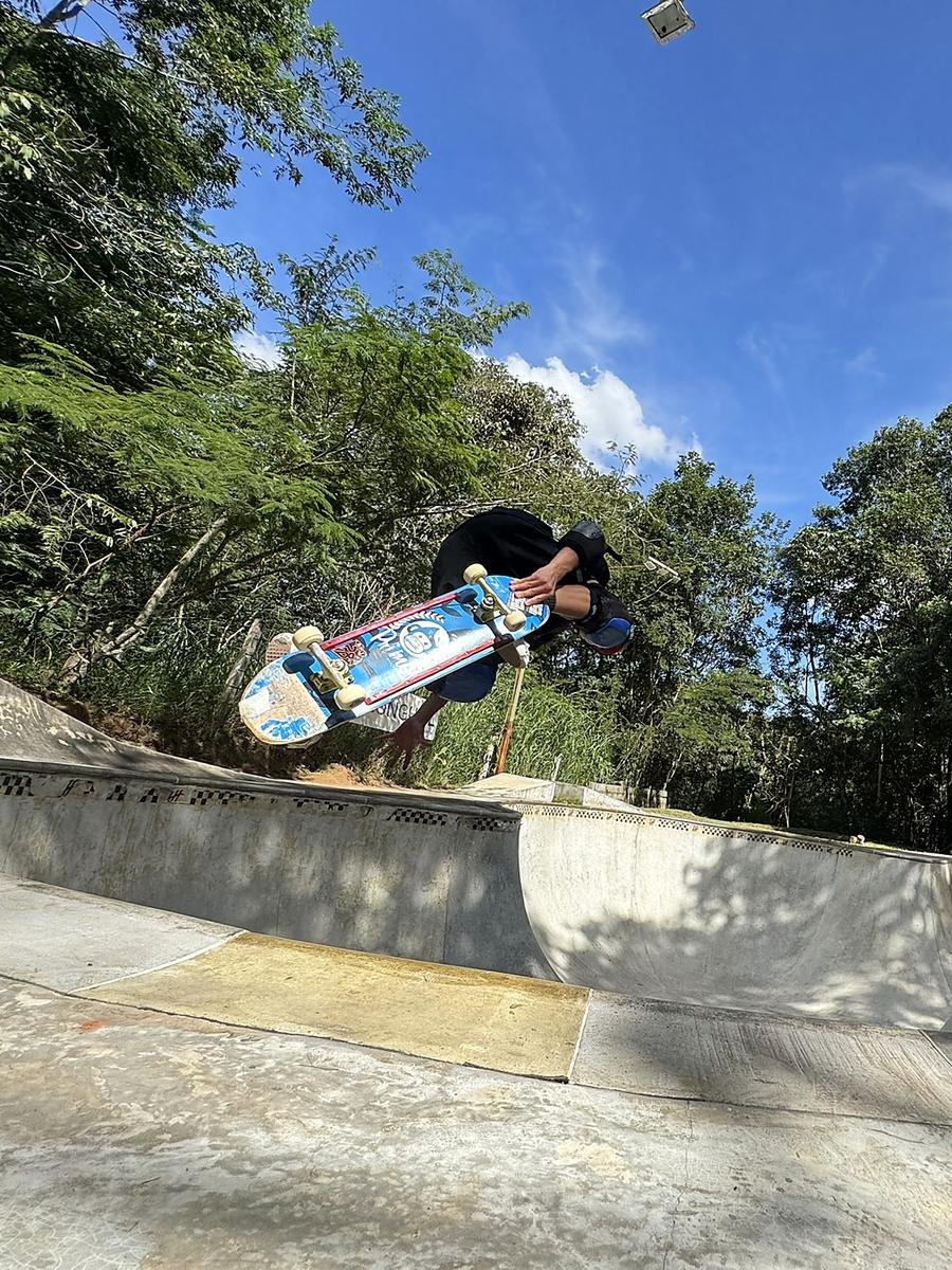 Air alto no bowl, com o shape na horizontal contra o céu